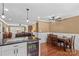 Open-concept living space showcasing a dining area with hardwood floors and a comfortable seating area with leather furniture at 314 Euclid Ave, Statesville, NC 28677