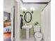 Charming bathroom featuring a pedestal sink, an oval mirror, and a shower with a white curtain at 319 S Oakland St, Gastonia, NC 28052