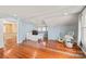 Bright bedroom featuring hardwood floors and an open doorway to another room at 319 S Oakland St, Gastonia, NC 28052