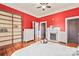 Bedroom features red walls, hardwood floors, built in bookcase and fireplace at 319 S Oakland St, Gastonia, NC 28052