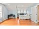 Well-lit bedroom with hardwood floors, comfortable bed, and a calming blue color scheme at 319 S Oakland St, Gastonia, NC 28052