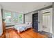 Bright bedroom with hardwood floors with a view of an en suite bathroom through an open door at 319 S Oakland St, Gastonia, NC 28052