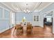 Dining room showcases coffered ceilings, hardwood floors, wainscoting and neutral blue walls at 319 S Oakland St, Gastonia, NC 28052