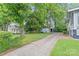 View of the side of the property including the driveway and trees at 319 S Oakland St, Gastonia, NC 28052