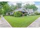 Well-manicured lawn with mature landscaping in front of this charming craftsman home at 319 S Oakland St, Gastonia, NC 28052