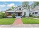 Charming home featuring a welcoming front porch, brick walkway, and well-manicured lawn, perfect for outdoor living at 319 S Oakland St, Gastonia, NC 28052