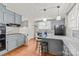 Kitchen with stainless steel appliances, granite counters, island with bar stools, and gray cabinetry at 319 S Oakland St, Gastonia, NC 28052