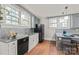 Kitchen with white and gray cabinets, stainless appliances, tin backsplash and granite countertops at 319 S Oakland St, Gastonia, NC 28052