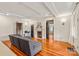 Bright living room with hardwood floors, fireplace, and gray sectional sofa with doorways leading to other rooms at 319 S Oakland St, Gastonia, NC 28052