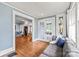 Inviting living room with hardwood floors, a comfortable gray sofa, and French doors leading to an outdoor space at 319 S Oakland St, Gastonia, NC 28052