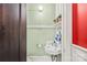 Small powder room with pedestal sink, shelf with plants, and mint green walls at 319 S Oakland St, Gastonia, NC 28052