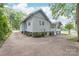 The rear of the house, showing a sunroom, siding, and the driveway at 319 S Oakland St, Gastonia, NC 28052
