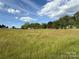 A bright day and beautiful sky show the lot at 33 Honeysuckle Ln, Taylorsville, NC 28681