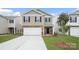 Charming two-story home featuring a two-car garage, brick accents, and landscaped front yard at 3402 Lacebark Ln, Gastonia, NC 28056