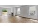 Open living room featuring hardwood floors, natural light, and fireplace at 3402 Lacebark Ln, Gastonia, NC 28056
