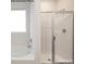 Bright bathroom featuring a soaking tub and a glass-enclosed shower, showcasing modern fixtures at 3407 Lacebark Ln, Gastonia, NC 28056