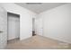 Bright bedroom featuring neutral carpet, a walk-in closet and white trim throughout at 3407 Lacebark Ln, Gastonia, NC 28056