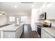 Open-concept kitchen with granite countertops, stainless steel appliances, and dark hardwood floors at 3407 Lacebark Ln, Gastonia, NC 28056