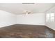 Spacious living room with hard wood floors, a modern fan, and lots of natural light at 3407 Lacebark Ln, Gastonia, NC 28056