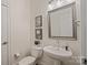 Clean, well-lit half-bath with modern sink, fixtures, stylish framed art, and a neutral color palette at 400 N Church St # 226, Charlotte, NC 28202