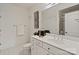 Bright bathroom featuring neutral tiles, a vanity with ample drawers, and a clear glass-enclosed shower at 400 N Church St # 226, Charlotte, NC 28202