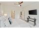 Modern bedroom boasts neutral colors, ceiling fan, and television on the wall at 400 N Church St # 226, Charlotte, NC 28202