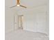 Bright, minimalist bedroom with neutral carpet and doors creating a serene and clutter-free ambiance at 400 N Church St # 226, Charlotte, NC 28202