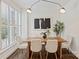 Bright dining area featuring a wooden table with cushioned chairs, contemporary lighting, and modern artwork at 400 N Church St # 226, Charlotte, NC 28202