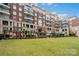 Beautiful brick condo building with manicured green space provides a serene urban retreat at 400 N Church St # 226, Charlotte, NC 28202