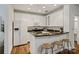 Modern kitchen featuring white cabinets, granite countertops, stainless steel appliances, and a breakfast bar with stools at 400 N Church St # 226, Charlotte, NC 28202