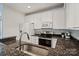 Updated kitchen with stainless appliances, granite counters, white cabinetry, and tiled backsplash for a modern, clean look at 400 N Church St # 226, Charlotte, NC 28202