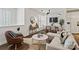 A comfortable living room featuring a modern sofa, leather armchair, and stylish decor against a bright neutral palette at 400 N Church St # 226, Charlotte, NC 28202