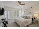 Bedroom features balcony access, plantation shutters, ceiling fan, and comfortable contemporary furnishings at 400 N Church St # 226, Charlotte, NC 28202