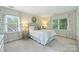 Well-lit bedroom with bright windows, soft carpeting, and comfortable furnishings at 5508 Kincross Ln, Charlotte, NC 28277