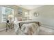 Comfortable bedroom featuring soft, neutral tones and natural light from bright, sunny windows at 5508 Kincross Ln, Charlotte, NC 28277