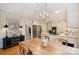 Bright eat-in kitchen area featuring a wooden dining table and view of the stainless steel appliances at 5508 Kincross Ln, Charlotte, NC 28277
