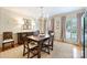 Traditional dining room with wooden table, chairs, chandelier, and large windows with neutral-toned curtains at 5508 Kincross Ln, Charlotte, NC 28277