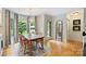 Charming dining room featuring hardwood floors, a rustic table, and large windows offering natural light at 5508 Kincross Ln, Charlotte, NC 28277