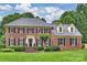 Beautiful two-story brick home with a well-manicured lawn and mature landscaping, offering classic curb appeal at 5508 Kincross Ln, Charlotte, NC 28277