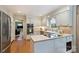 Well-lit kitchen with white cabinets, stainless steel appliances, and an open layout at 5508 Kincross Ln, Charlotte, NC 28277