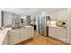 Open-concept kitchen featuring modern appliances, a kitchen island, and hardwood floors at 5508 Kincross Ln, Charlotte, NC 28277