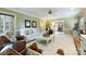 Bright and airy living room features a white sofa, patterned chairs, and a view into another room at 5508 Kincross Ln, Charlotte, NC 28277