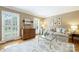 Well-lit living room featuring hardwood floors, neutral paint, and plantation shutters, offering a serene and stylish space at 5508 Kincross Ln, Charlotte, NC 28277