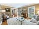 Bright living room with hardwood floors, shuttered windows, and tasteful decor, creating a warm and inviting atmosphere at 5508 Kincross Ln, Charlotte, NC 28277