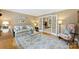 Cozy living room featuring hardwood floors, French doors, and neutral decor, ideal for relaxation and entertaining at 5508 Kincross Ln, Charlotte, NC 28277