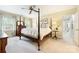 Spacious main bedroom with a four-poster bed, plush carpet, and natural light from the windows at 5508 Kincross Ln, Charlotte, NC 28277