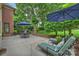 A patio with an outdoor table and lounge chairs, set within a beautifully landscaped yard provides an ideal outdoor experience at 5508 Kincross Ln, Charlotte, NC 28277