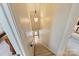 Carpeted staircase leading to a lower level, with a light fixture overhead at 5508 Kincross Ln, Charlotte, NC 28277