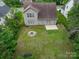 Aerial view of backyard showing firepit, lawn, fenced yard, patio, and sunroom at 5656 Cambridge Bay Dr, Charlotte, NC 28269
