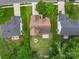 Aerial view of home showing firepit, large backyard, patio, neighboring homes, and mature trees at 5656 Cambridge Bay Dr, Charlotte, NC 28269